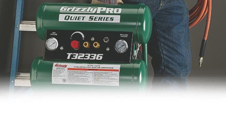 someone carrying an air compressor and air hose