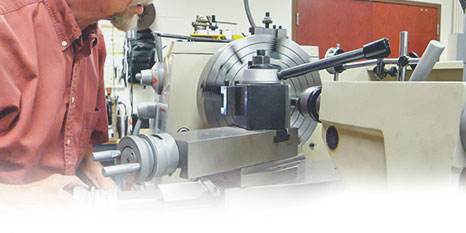 Someone working on a metal lathe