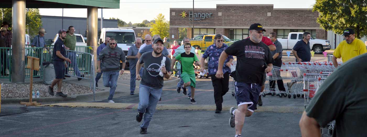 customers run to get first pick at machines once the doors open at a tent sale