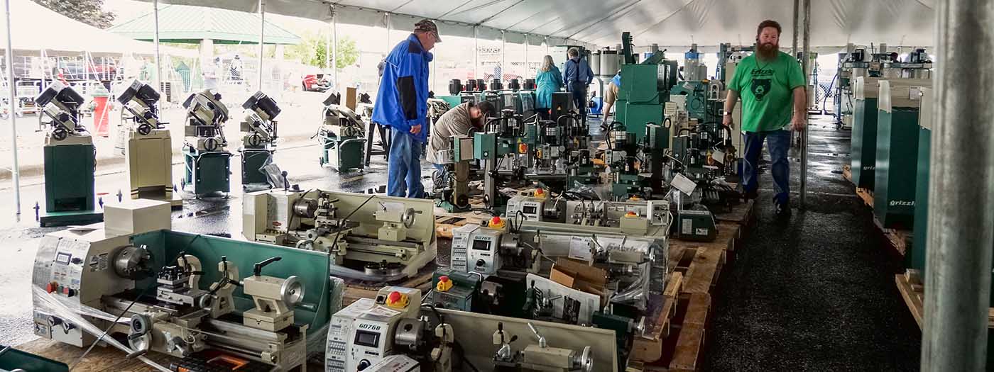 Customers shopping for metalworking machines in the tent